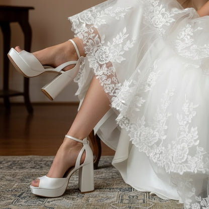 Off-white satin bridal platform heels with 10 cm (3.94 in) block heel, 2 cm (0.79 in) platform, square peep toe, and removable ivory bows
